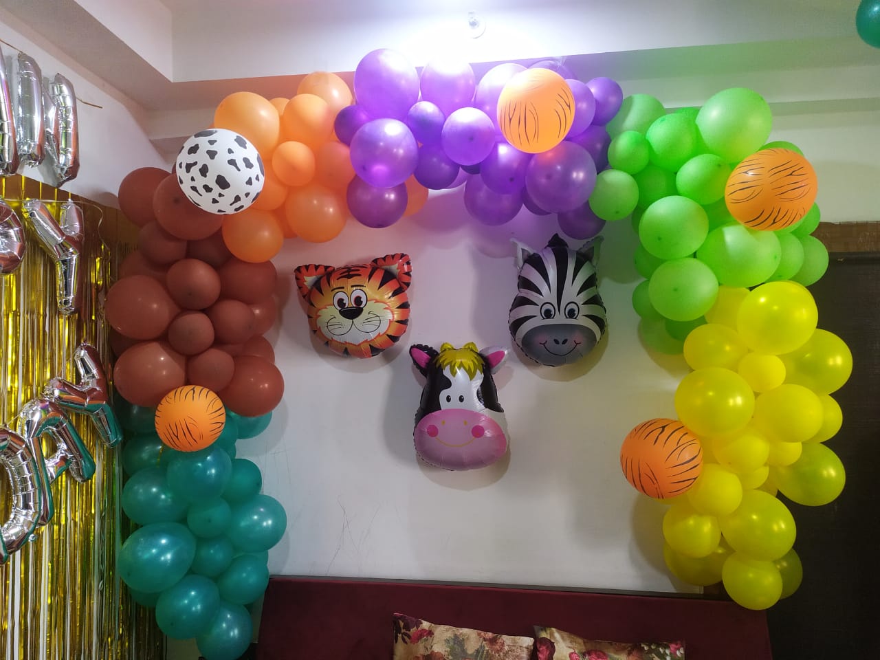 Yellow, Green, Purple, Orange, Brown, Blue & White Balloons Decoration With Tiger, Cow & Zebra Face Foil Balloons & Golden Metallic Curtain.